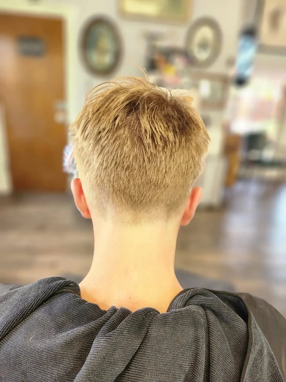 Back view of a taper haircut styled by Jill at the barbershop