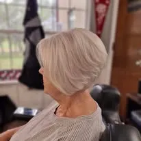 Silver bob haircut styled by Jill, shown from behind in a salon chair